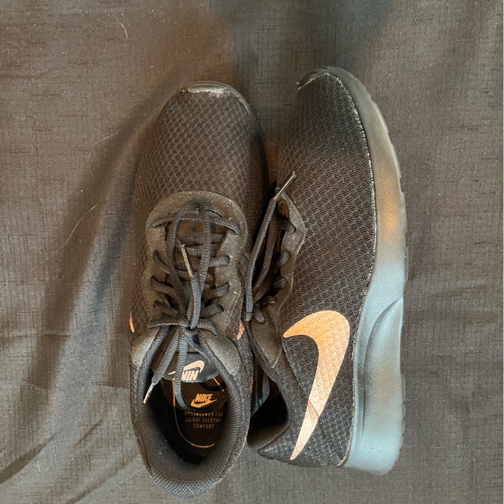 Black Nikes with rose gold accents in size 11 for women